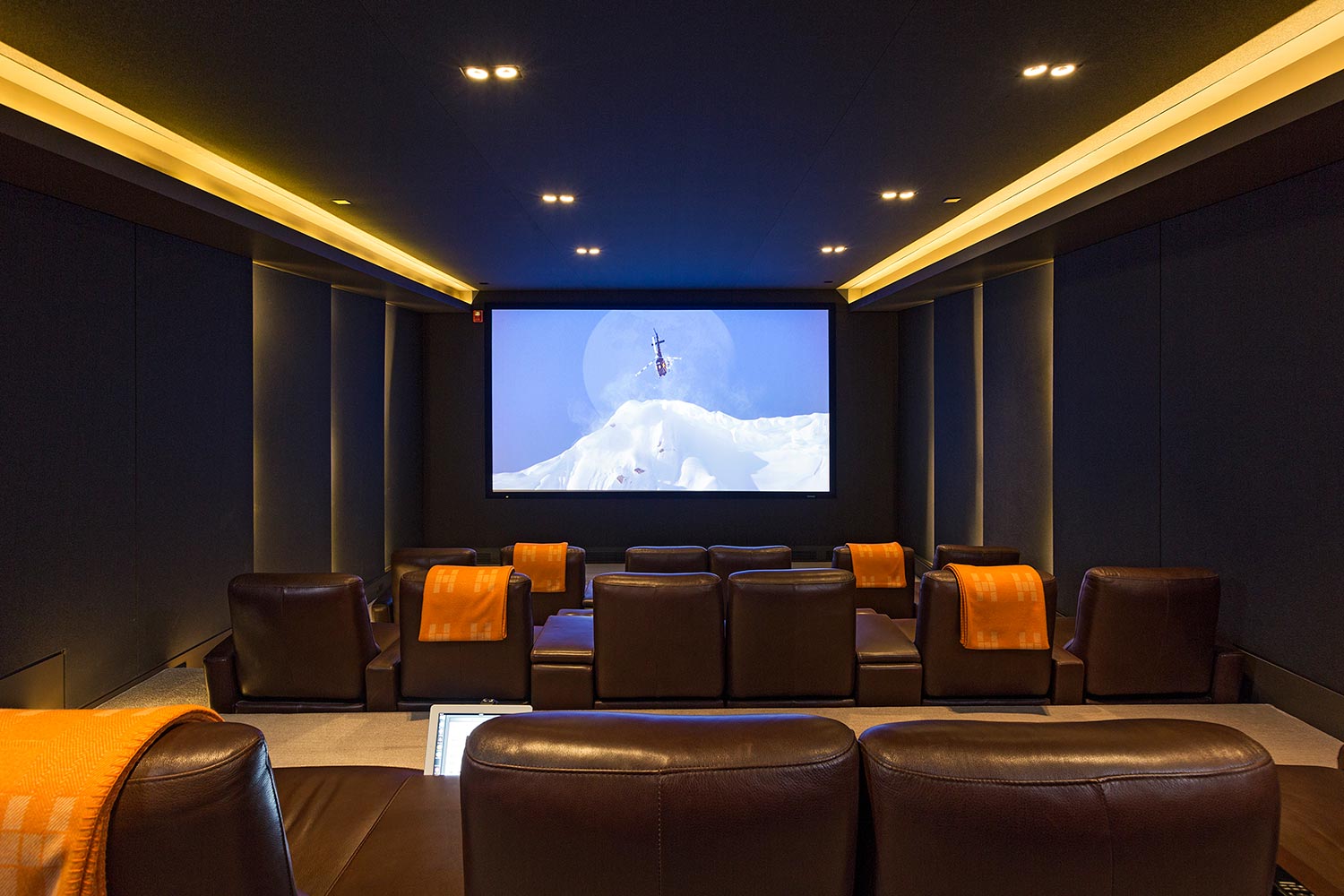 Home theater front with brown seating and orange blankets