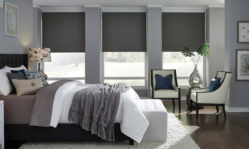 Blackout shades by Lutron in a cool grey bedroom